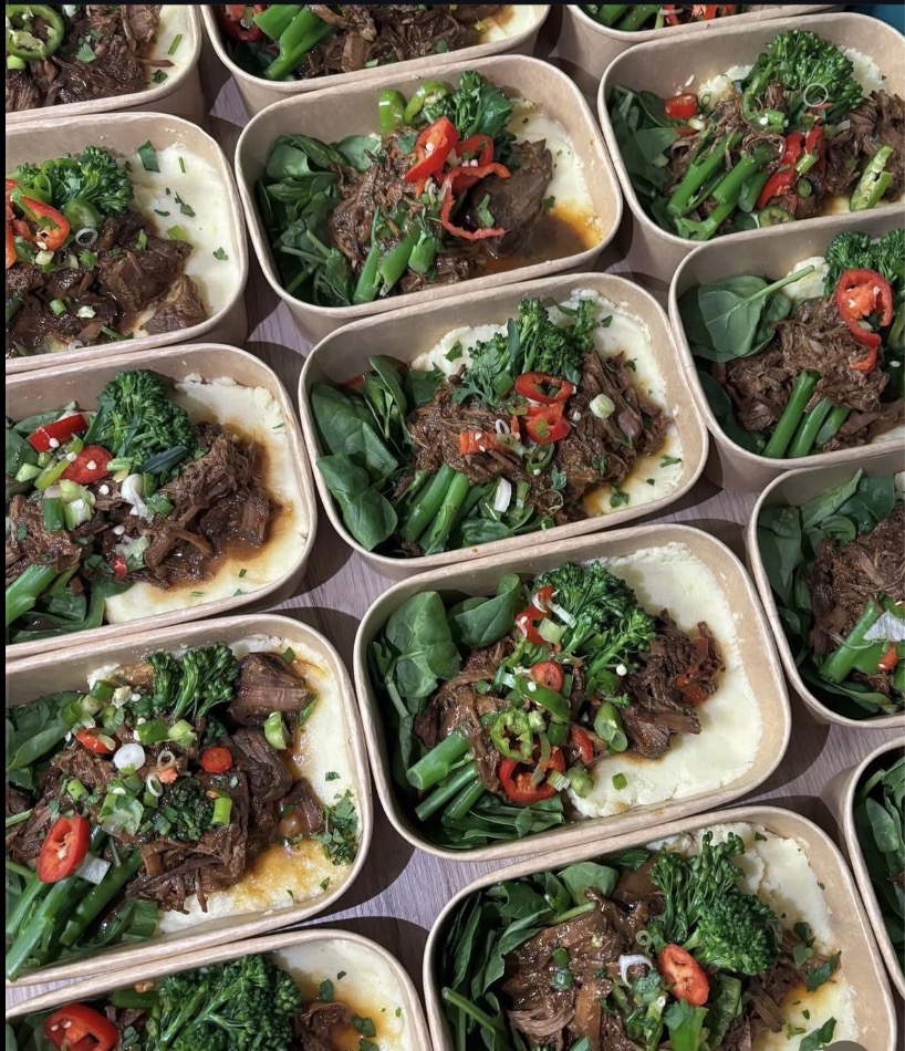 Trays of slow-cooked beef with mashed potato, spinach, tenderstem broccoli and red chilli