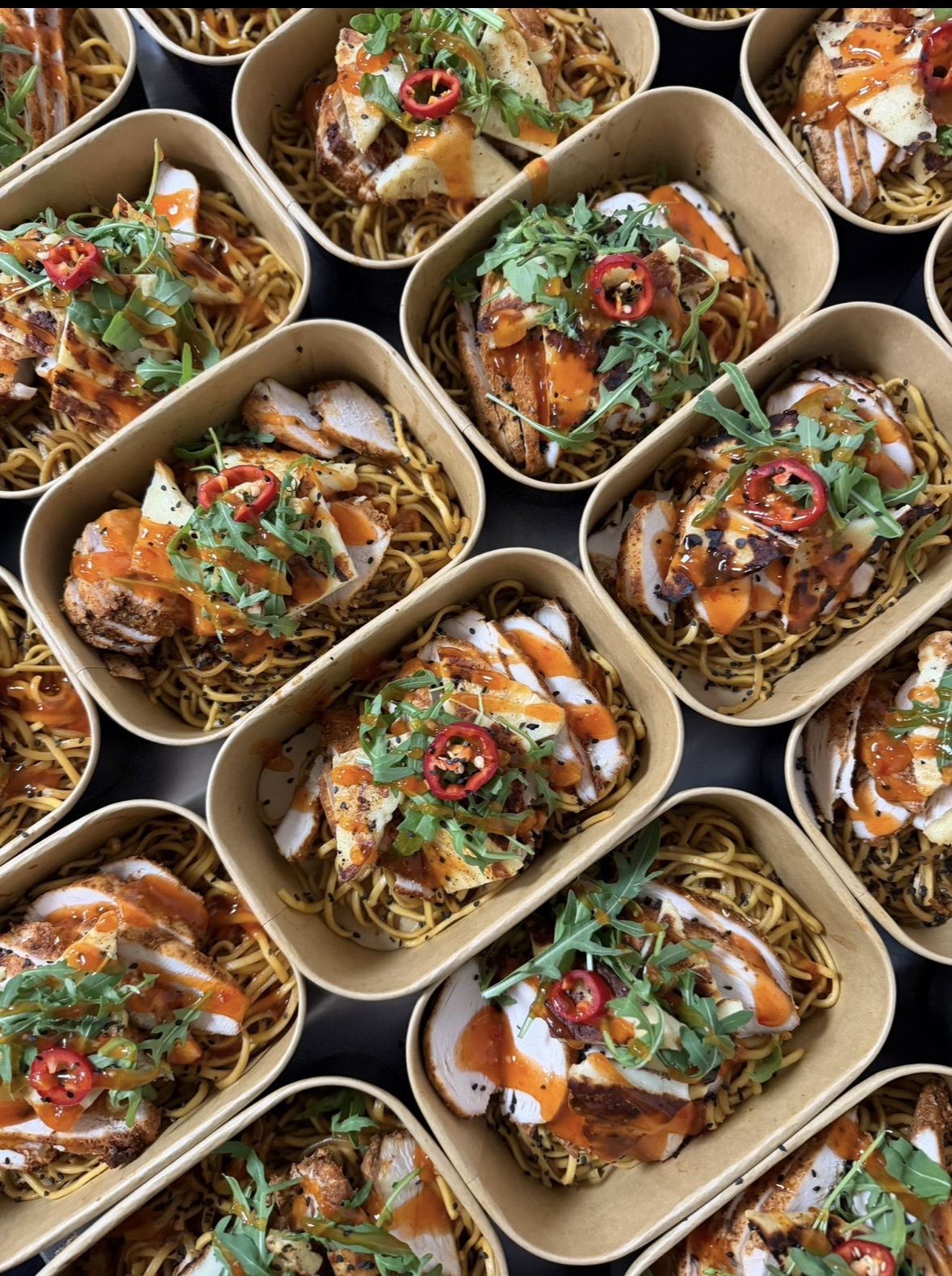 Sliced chicken and halloumi over noodles with rocket, chilli and sweet chilli sauce